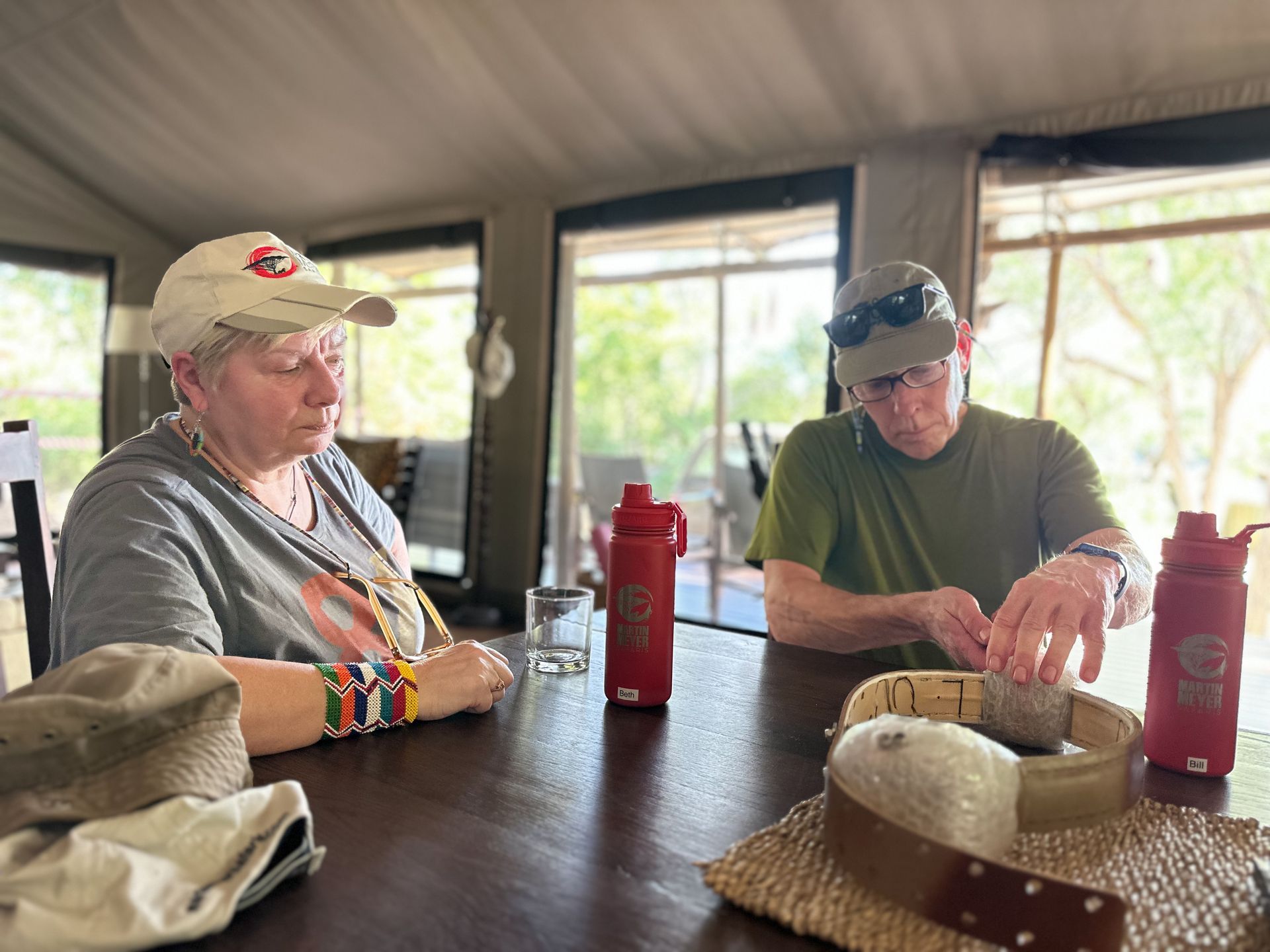 A Lion Collar is visible on a table with guests on a conservation safari with Martin Meyer Safaris