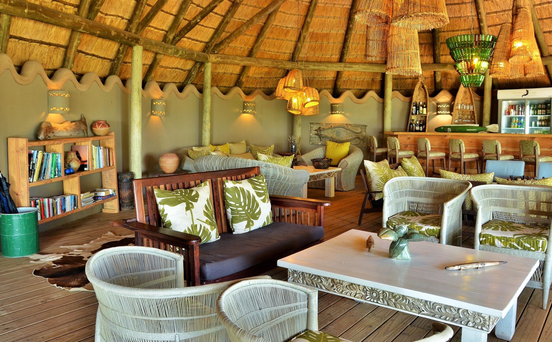 A living room with wicker furniture and a thatched roof