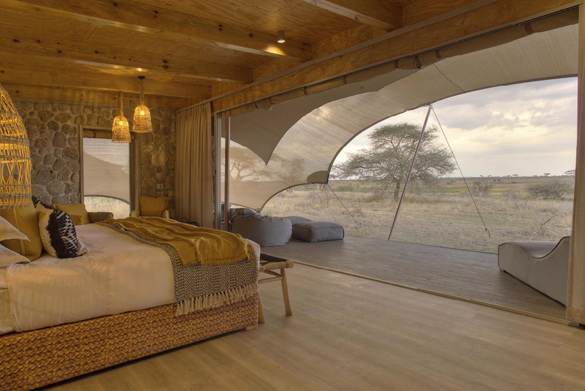 A bedroom with a large bed and a view of a field.