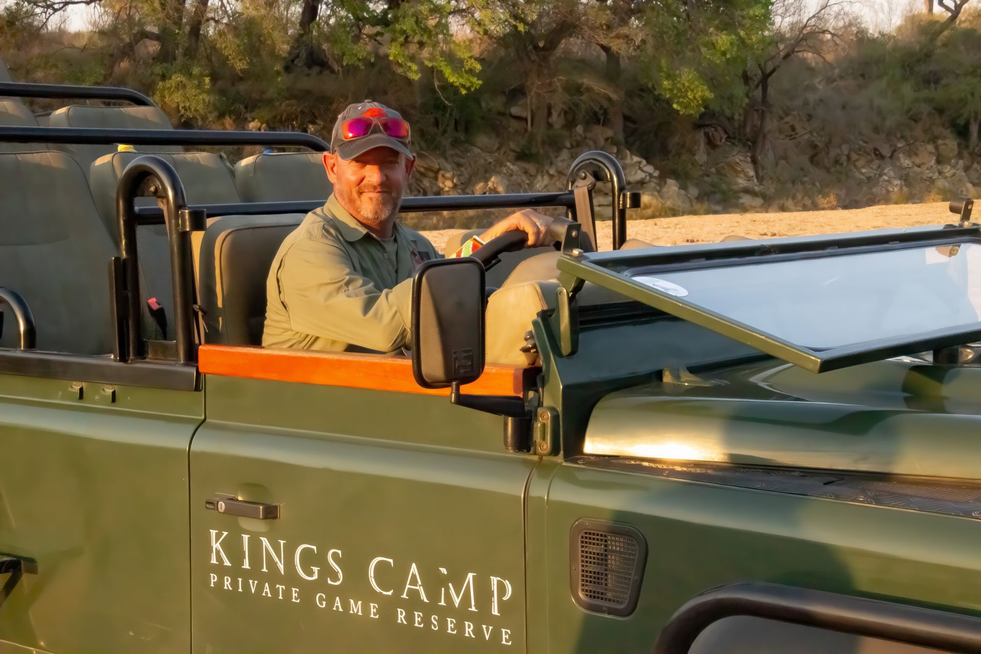 Martin Meyer Private Guide  is sitting in the driver 's seat of a kings camp vehicle .