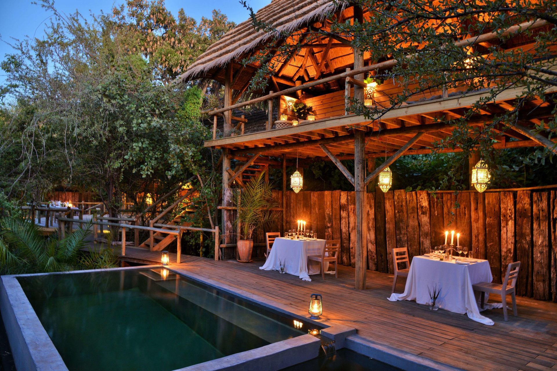 A wooden house with a swimming pool in front of it