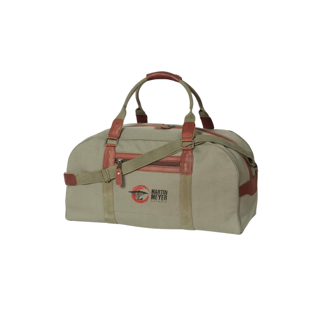 Dark green duffel bag with brown leather accents and straps, logo on front.