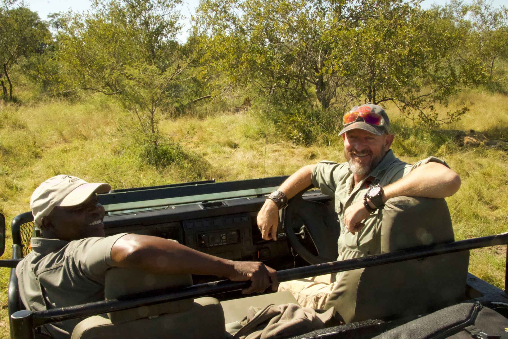 Martin and a local guide at a lion sighting. Private Specialist Guides
