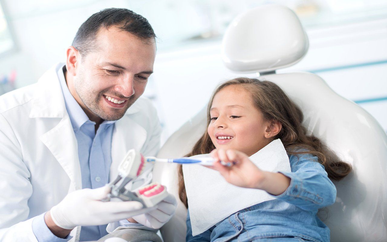 Dentist Teaching Child How To Brush — Bakersfield, CA — Just For Kids Dental Group