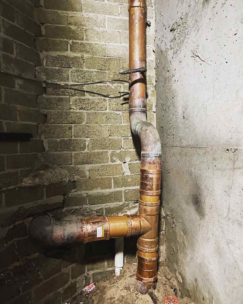 A Copper Pipe Is Sitting In The Corner — Todd Williams Plumbing and Gas Fitting In Forster, NSW