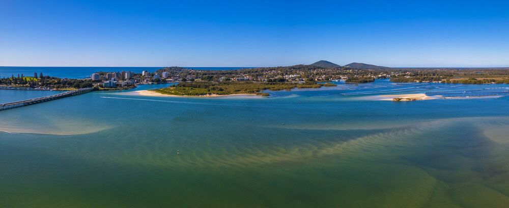 An Aerial View Of A Body Of Water With A City In The Background — Todd Williams Plumbing and Gas Fitting In Tuncurry, NSW