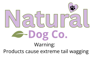 Natural dog logo in purple with a green leaf, purple heart with paw print and the slogan Products cause extreme tail wagging