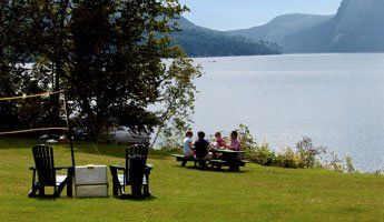 Family Sitting at Picnic Table next to Lake Willoughby in Vermont