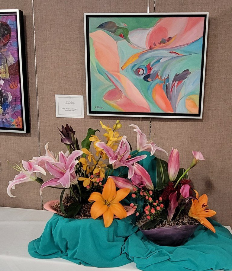 Detailed illustration of tropical flowers and leaves in shades of yellow, green, and red against a white background.