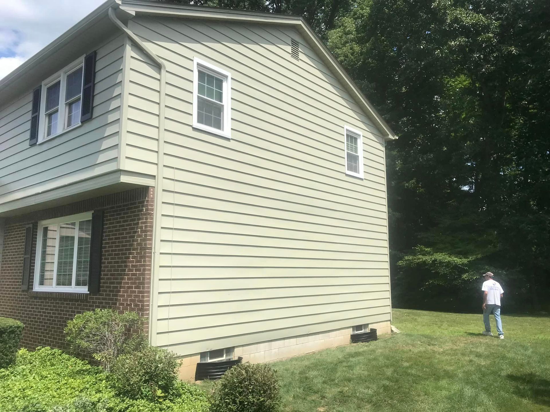 Man Stands in Front of a House with a Green Siding — Poland Township, OH — Donnadio Painting