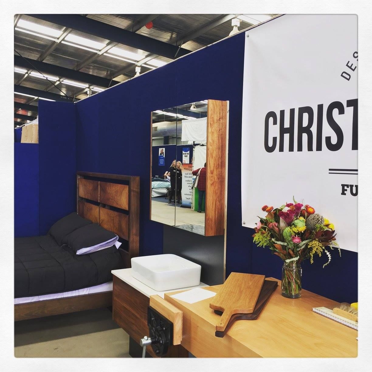 Furniture display: a bed, desk, mirror, and banner with