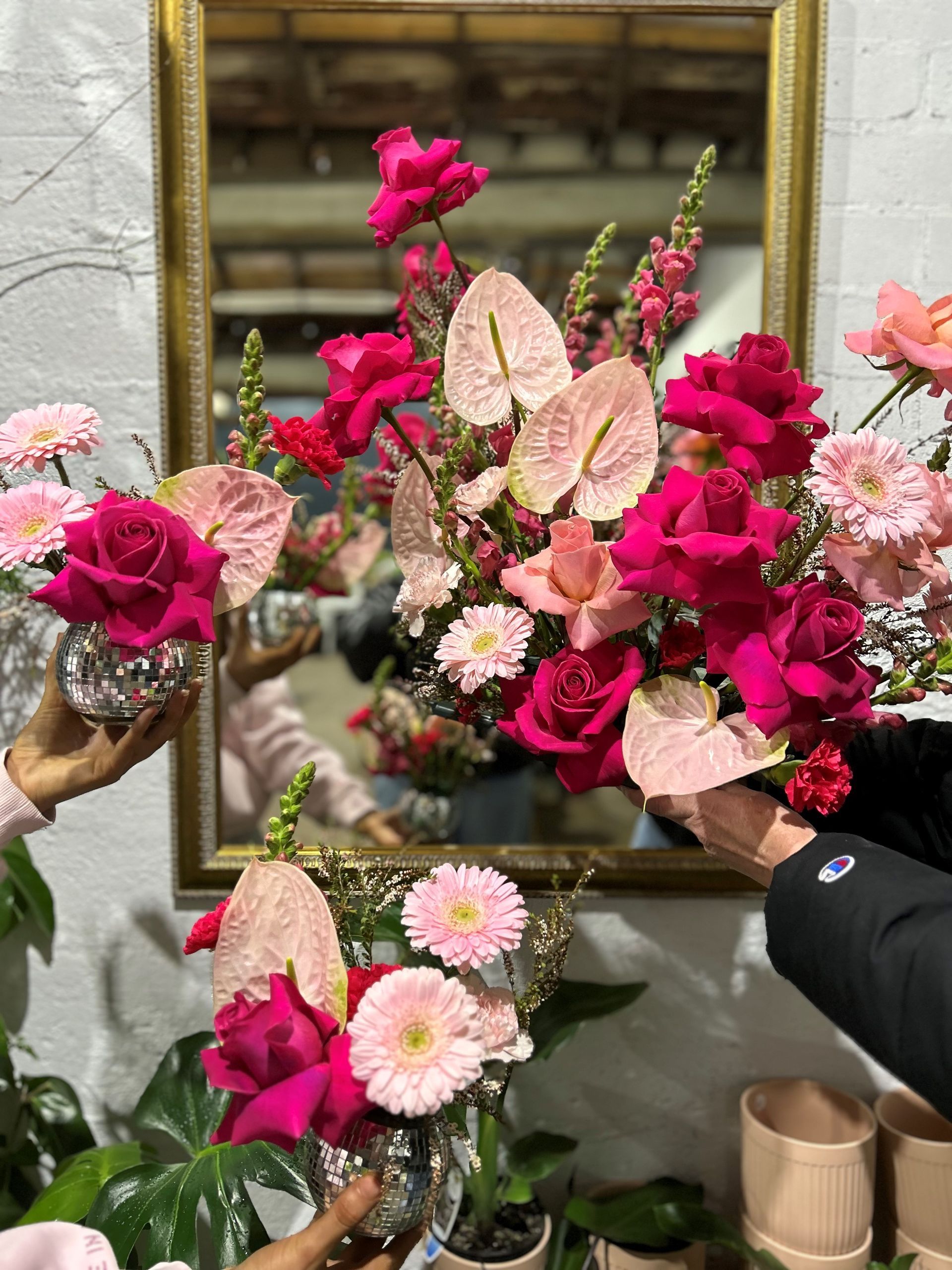 An engagement ring is sitting on top of a succulent plant.