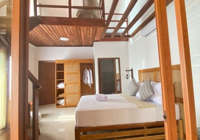 A bedroom with a king size bed and a bunk bed