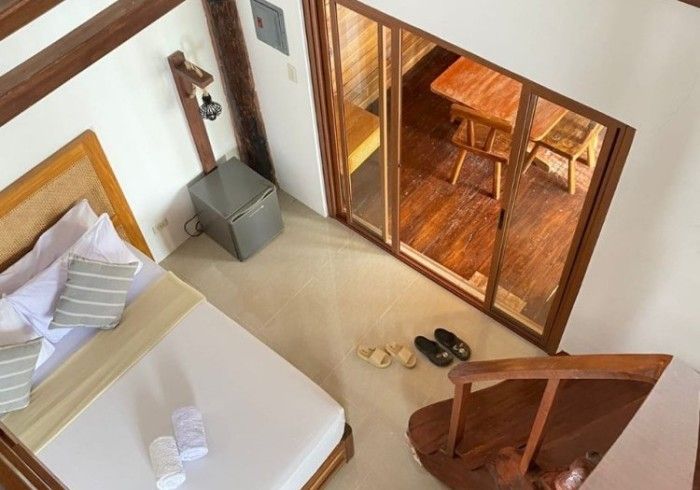 An aerial view of a bedroom with a bed and stairs
