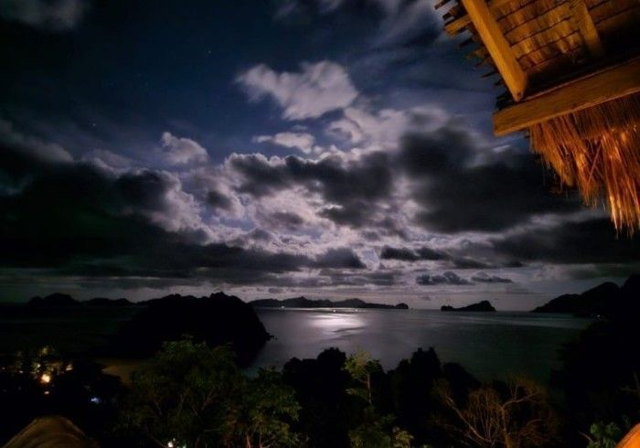 A full moon shines over a body of water
