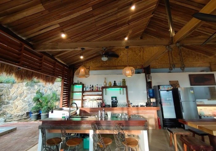 A kitchen with a ceiling fan and a refrigerator