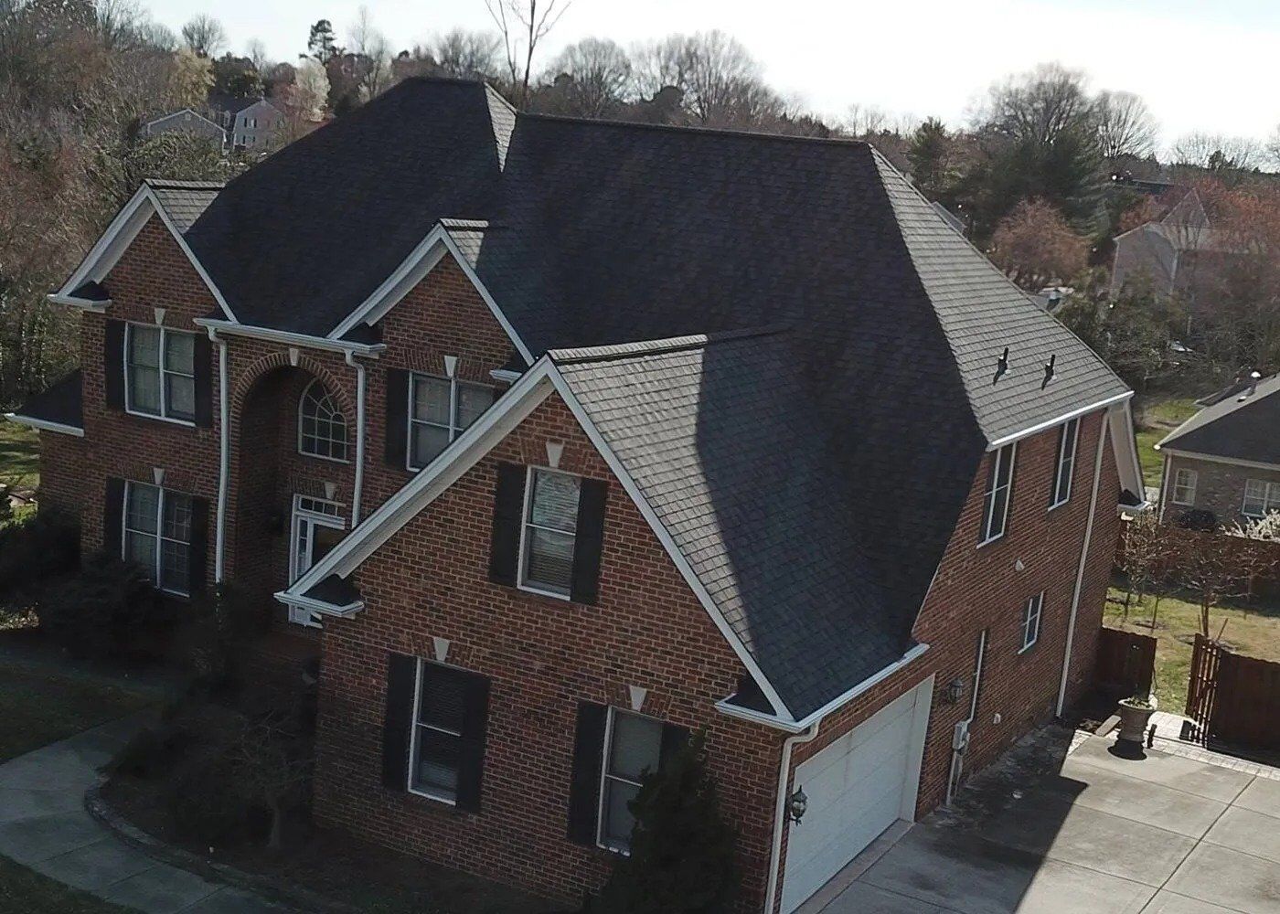 A house featuring a distinctive brick roof, showcasing a unique architectural style.