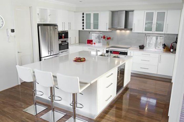 A Kitchen With White Cabinets and Stools — Attention to Detail Cleaning Services & Deck Coating Darwin in Casuarina, NT