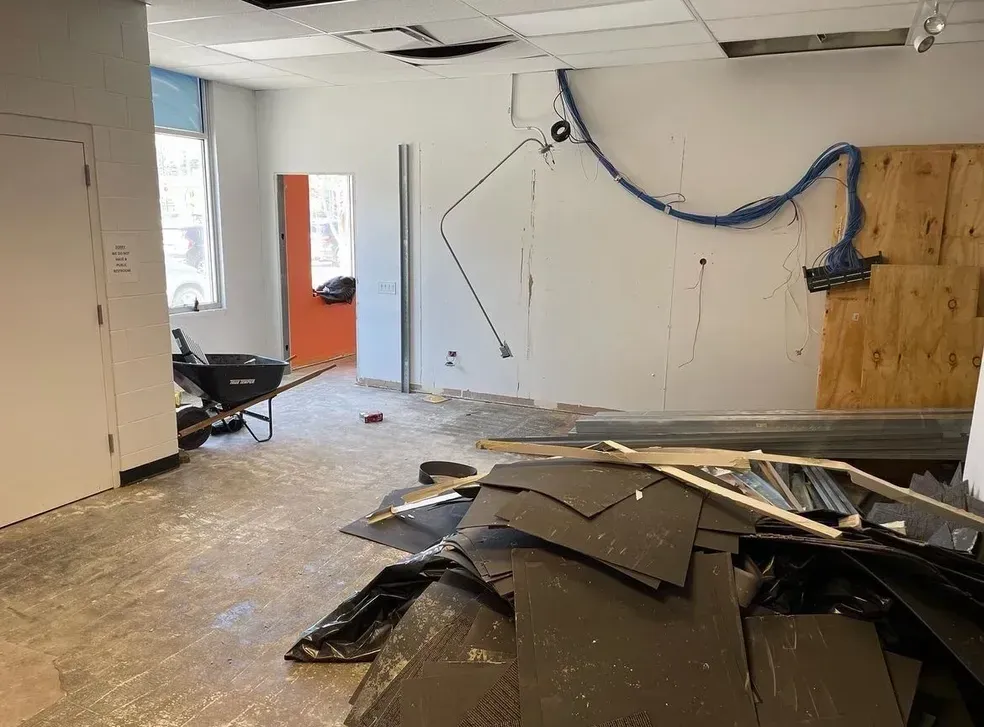 A room with a lot of pieces of wood on the floor.