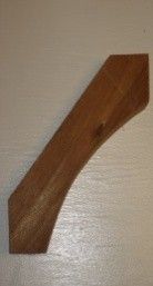 Wooden decorative bracket, brown, with a curved design and angled ends.
