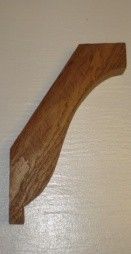 Wooden decorative bracket with curved design, brown finish.