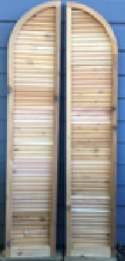 Wooden shutter with a curved top, mounted on a wall.