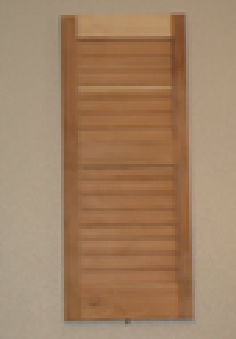 Wooden half-circle vent on a textured gray wall. It has horizontal slats for ventilation.