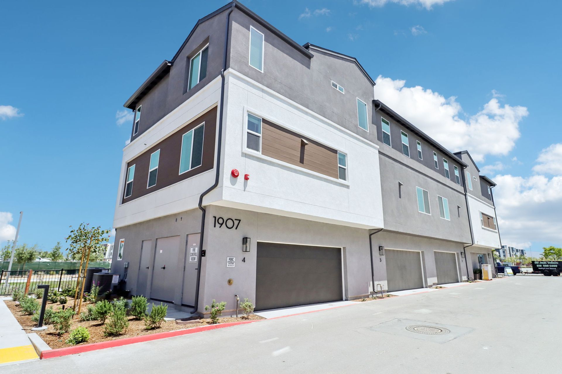 A large apartment building with a lot of windows and garages