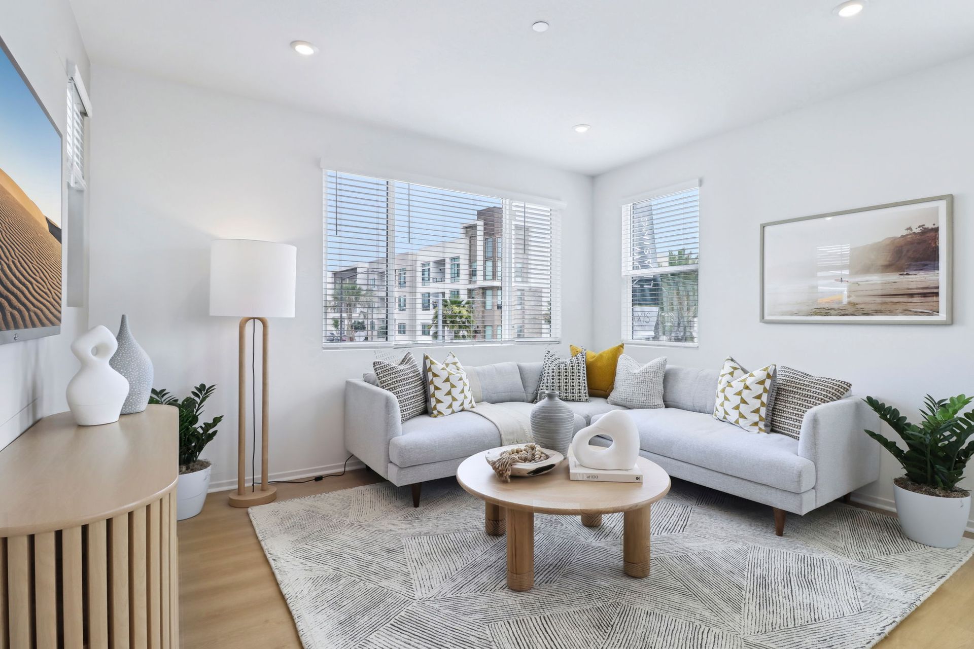 A living room with two couches , a coffee table , and a television.