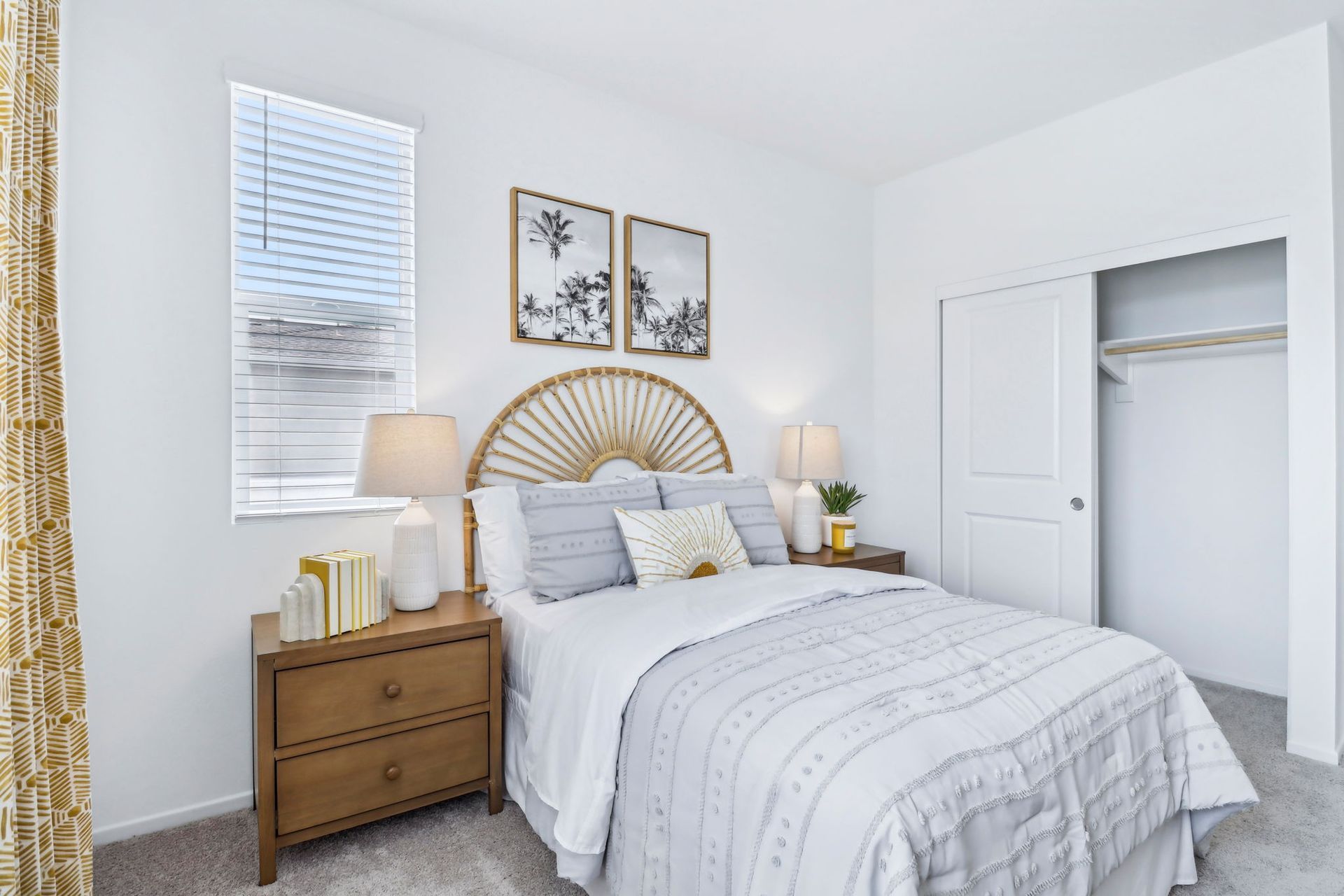 Bedroom with bed, nightstands, closet, window, and decor. Neutral color scheme.