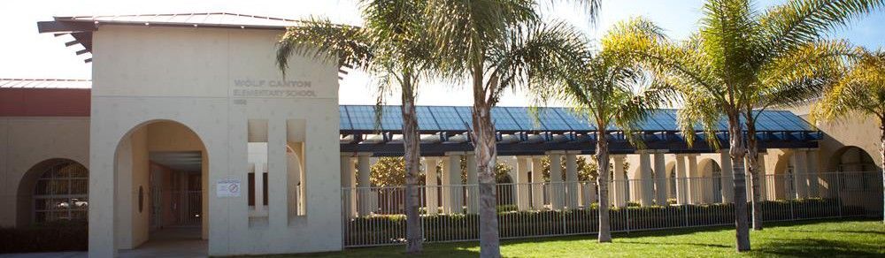 A building with a lot of palm trees in front of it