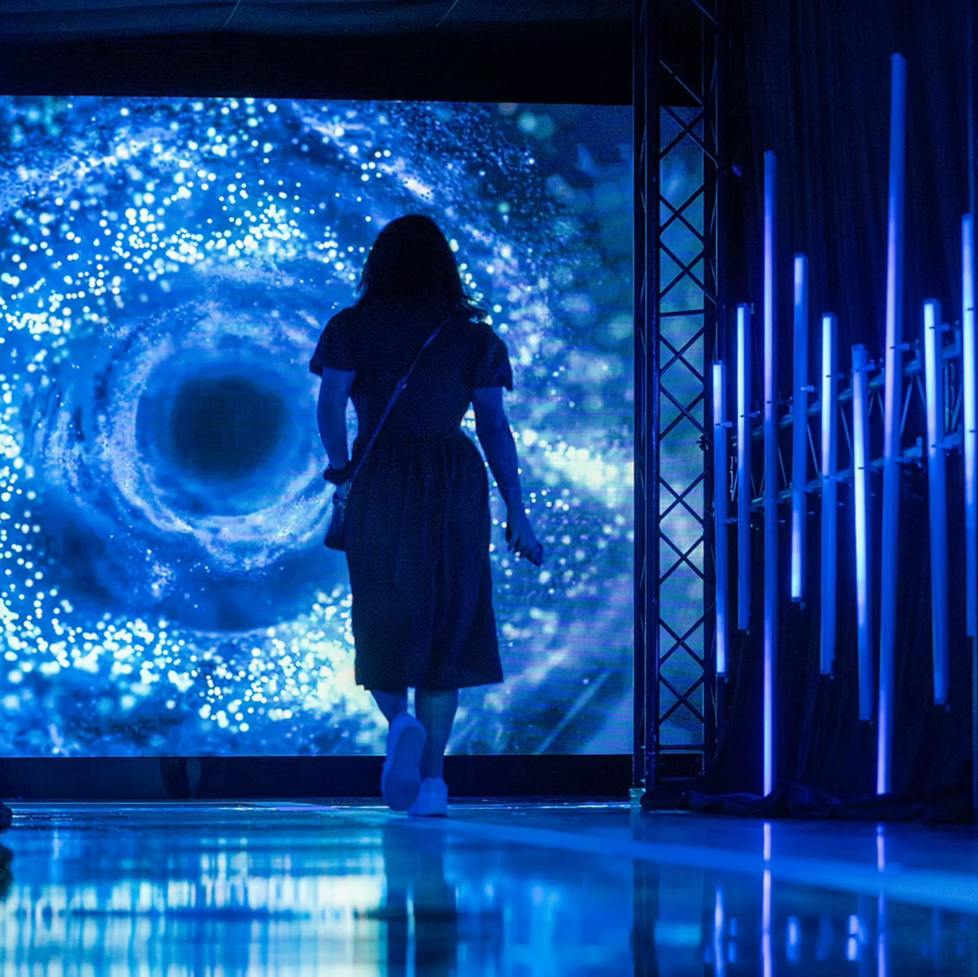 woman in front of large led screen