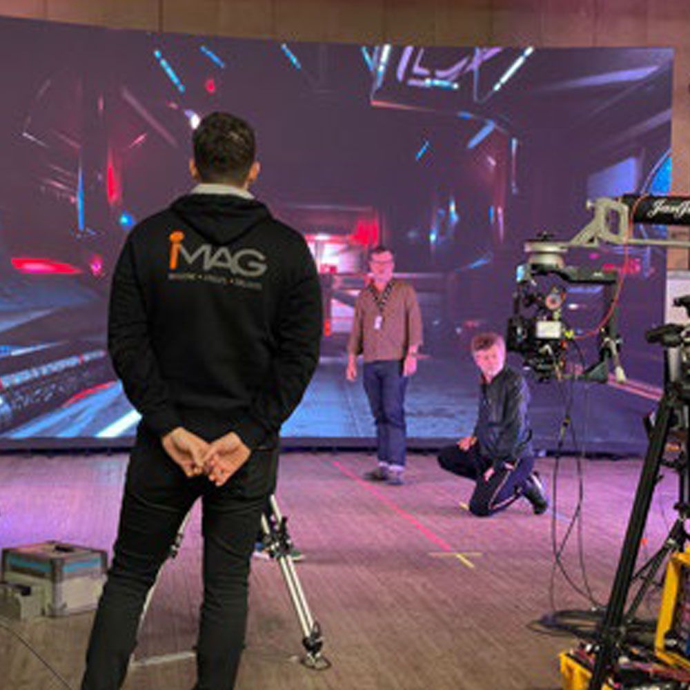 Alex from iMAG works with imaginarium on set