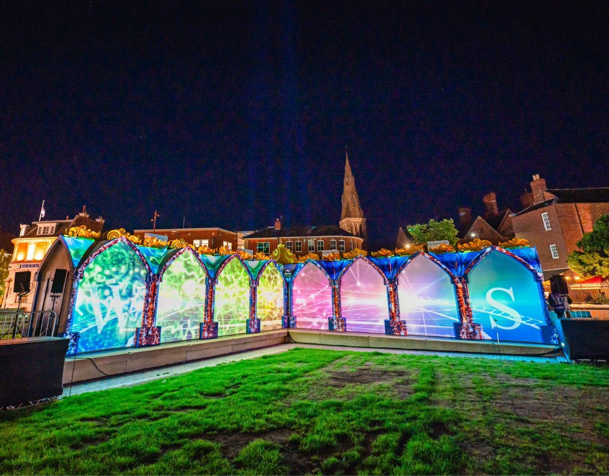 image of a projection-mapped building on grass