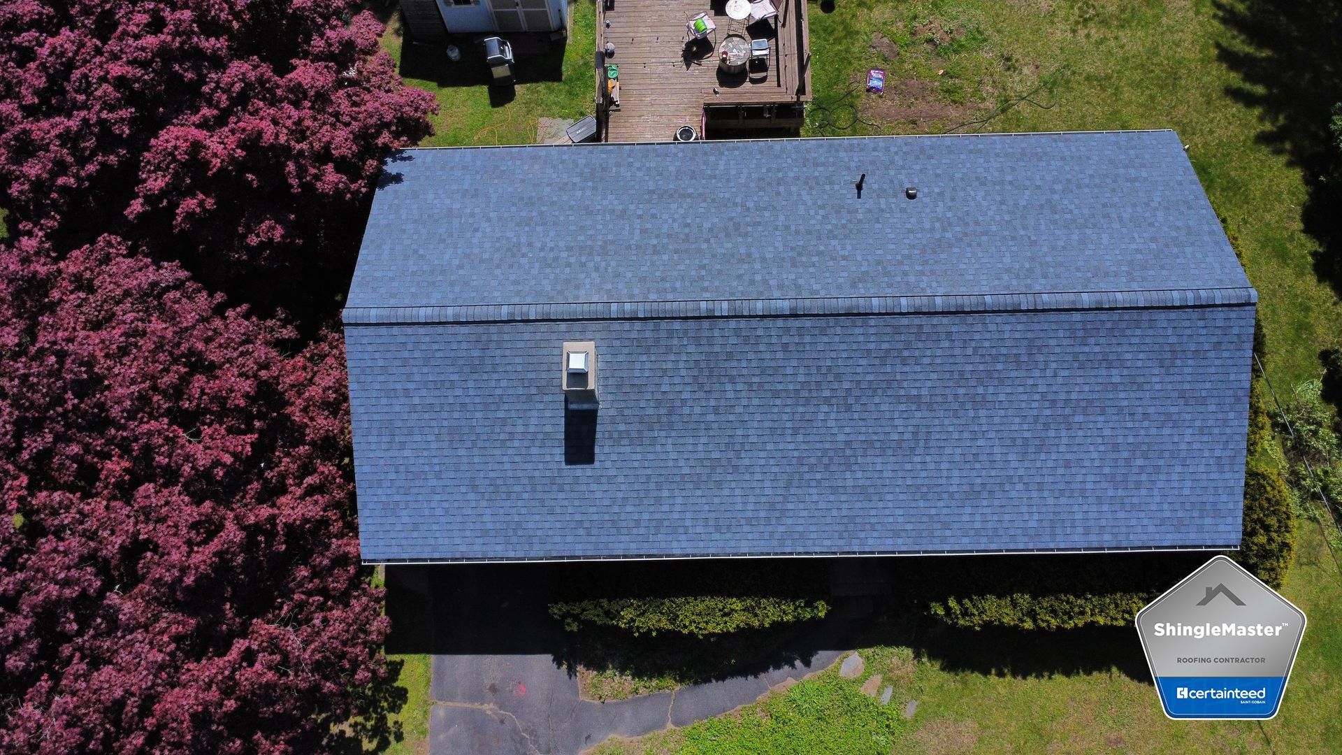 An aerial view of a house with a blue roof.