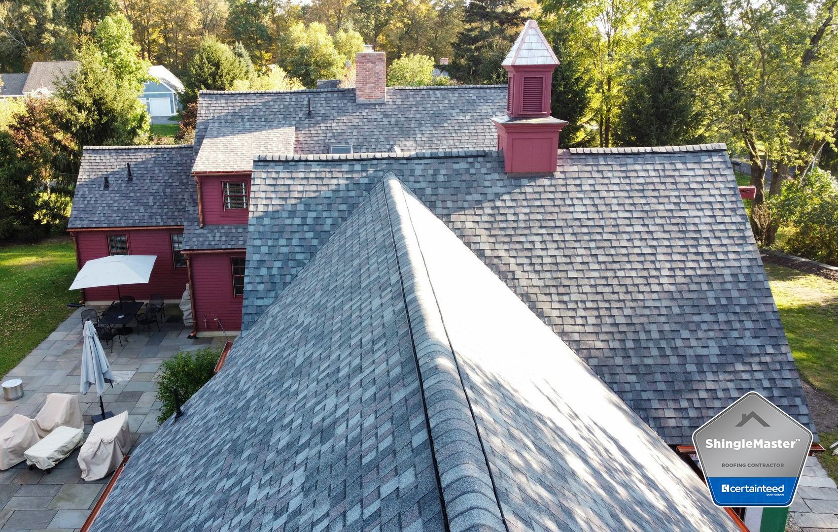 An aerial view of a large house with a gray roof.