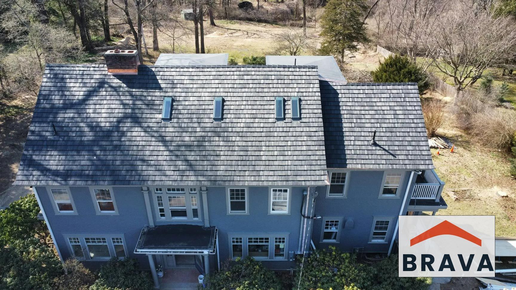 An aerial view of a large house with a slate roof.