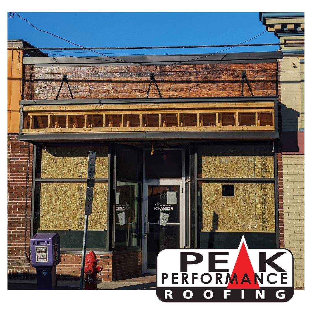 A building with a peak performance roofing logo on it
