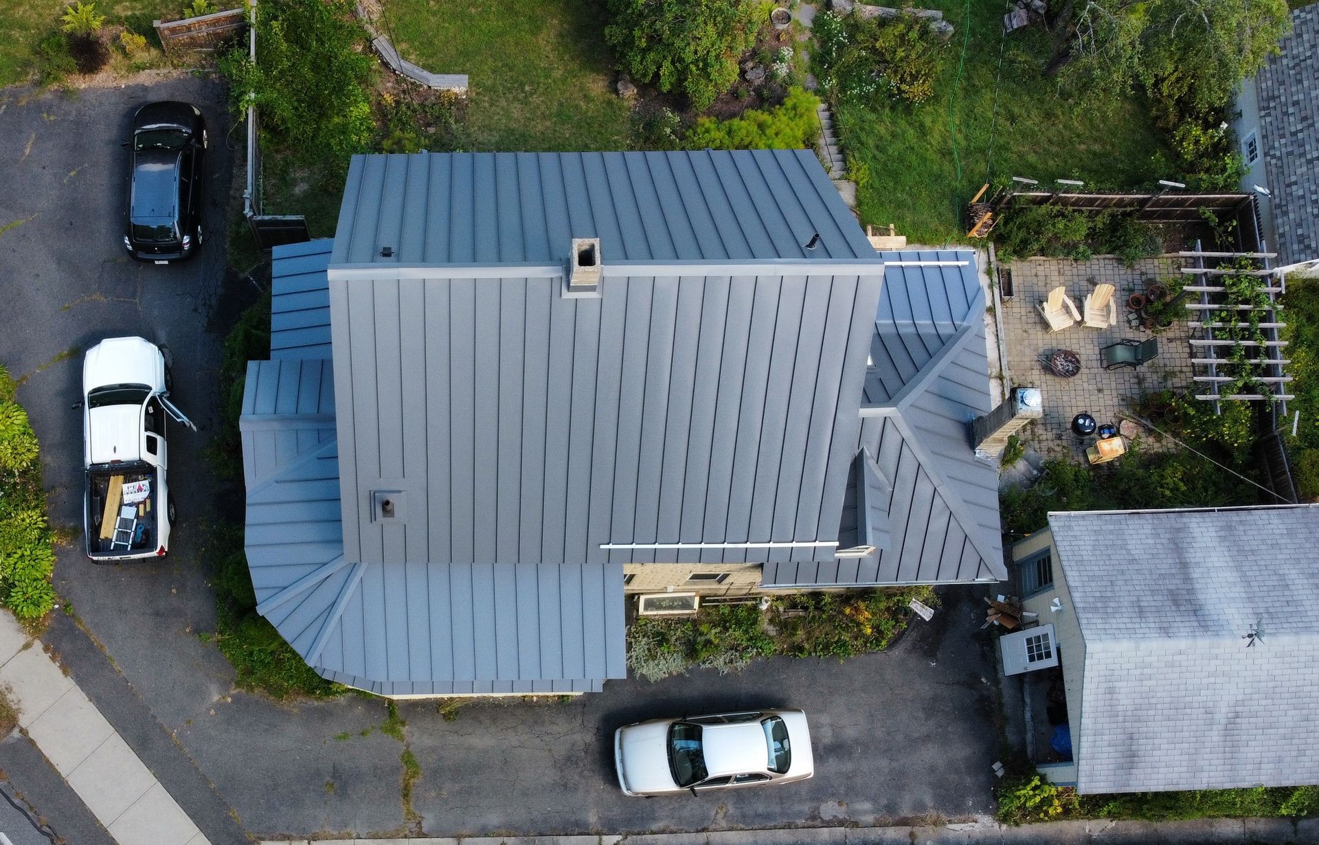 An aerial view of a house with a metal roof