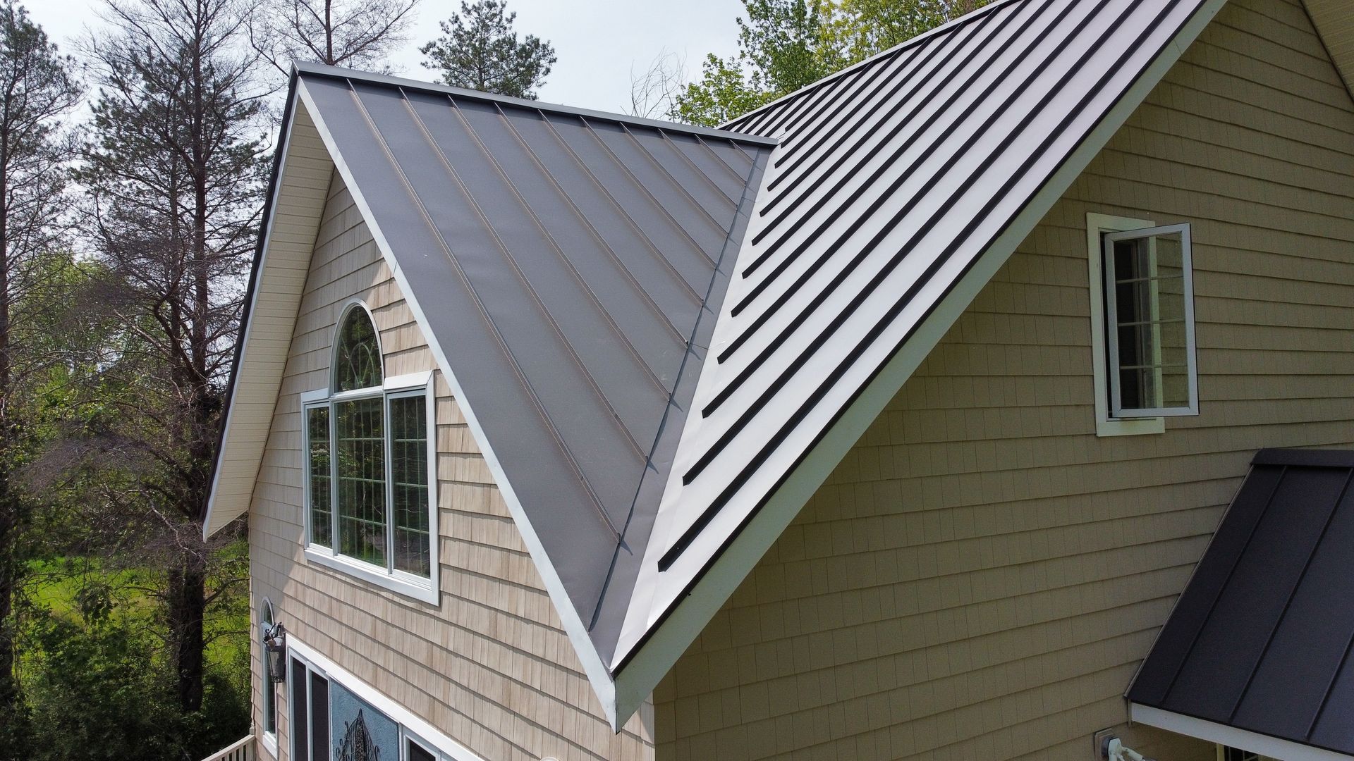 An aerial view of a house with a metal roof.