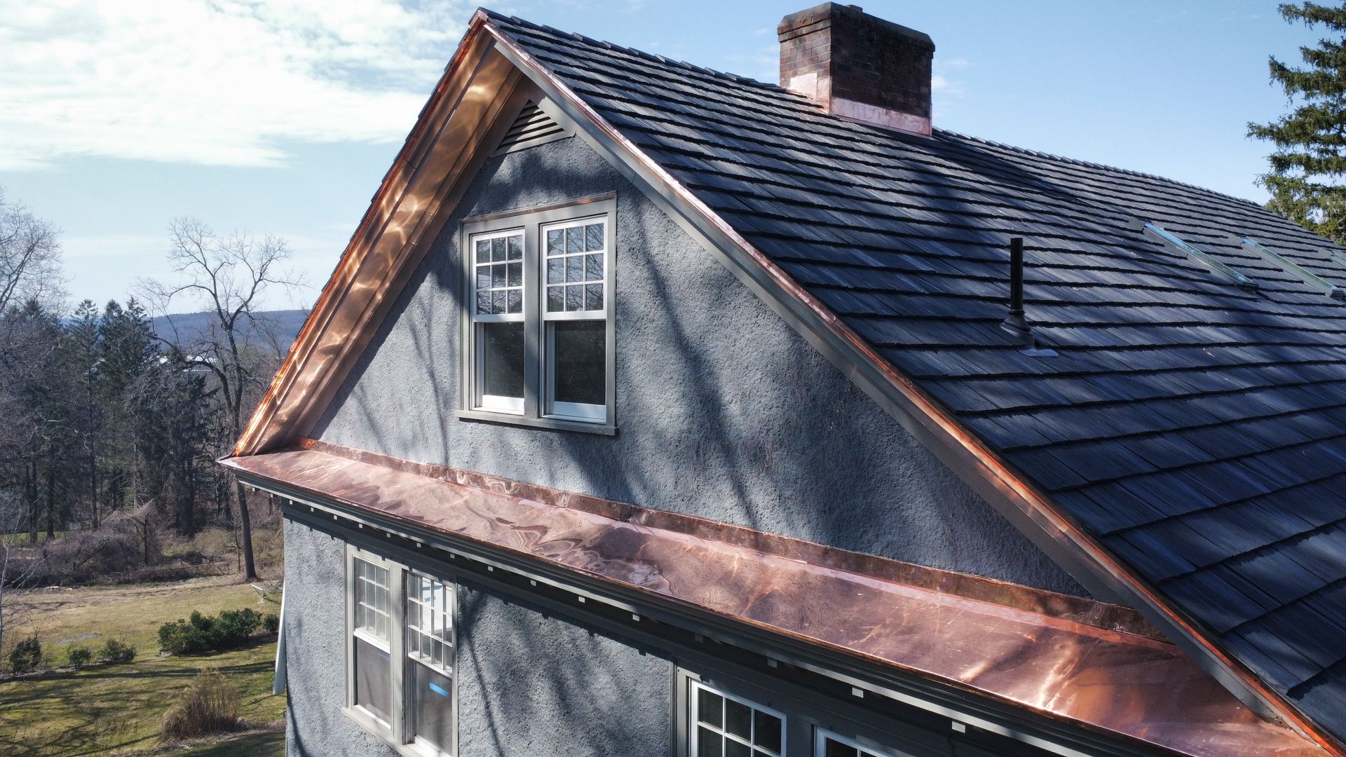 A house with a copper roof and a chimney A house with a copper roof and a chimney