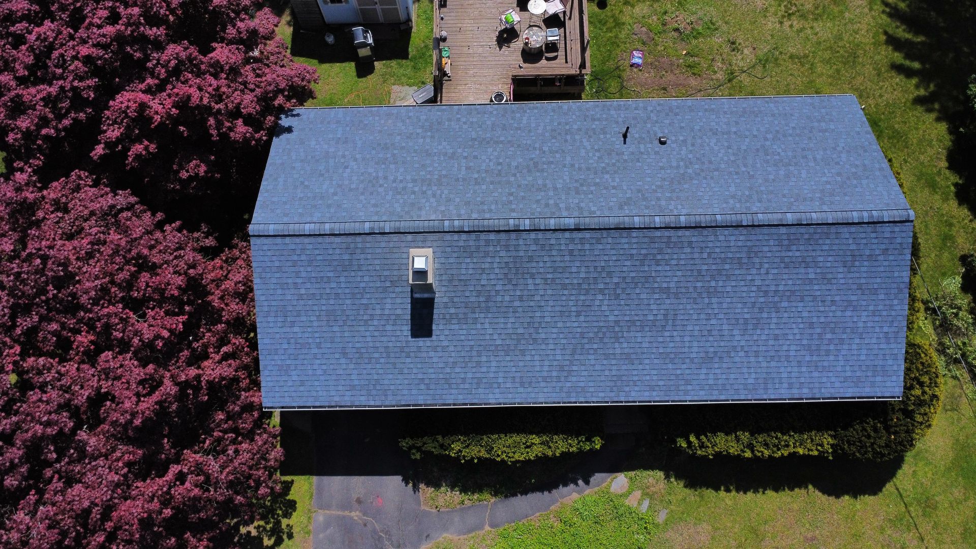 An aerial view of a house with a blue roof