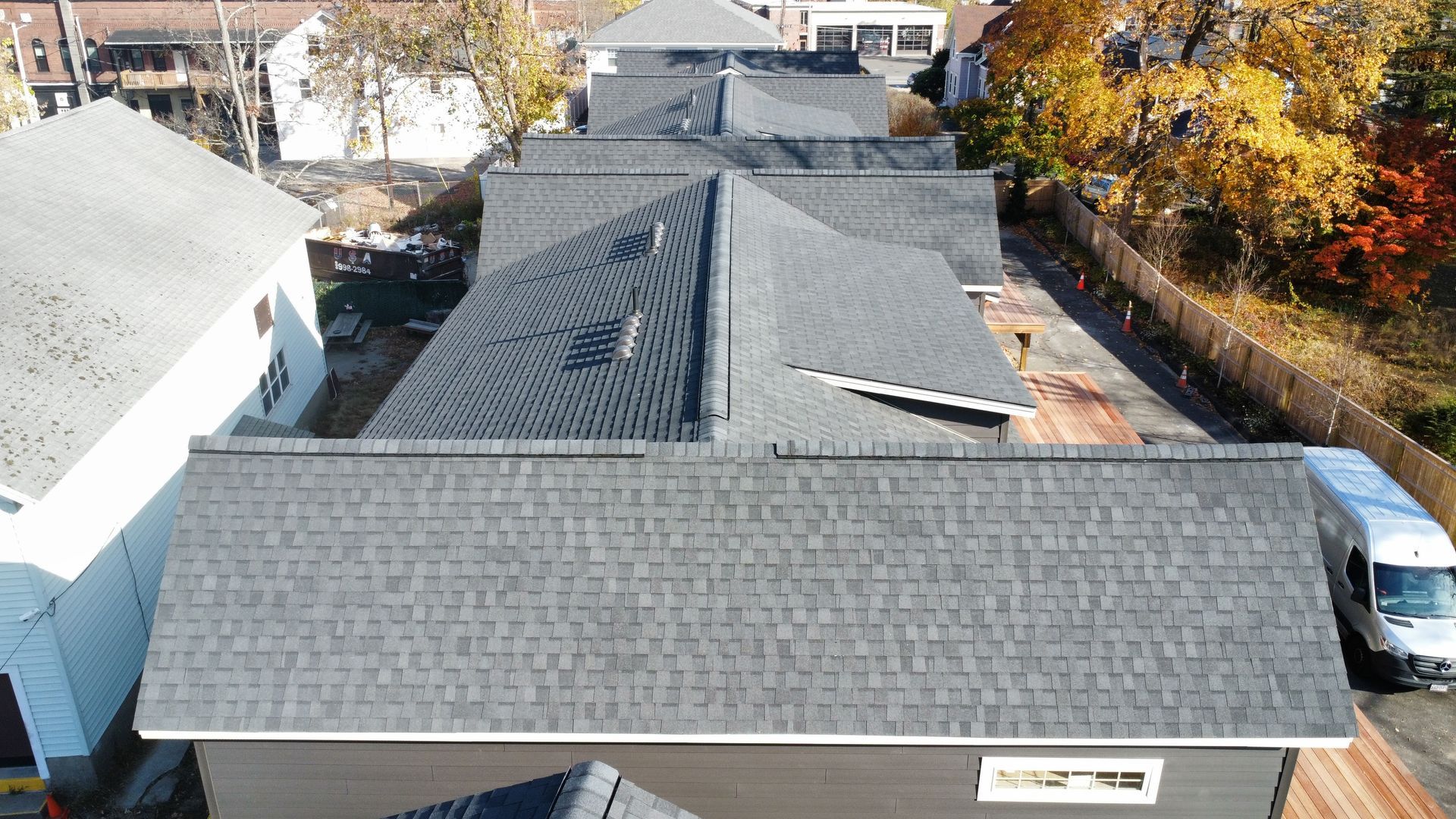 An aerial view of a row of houses with a truck parked in front of them.