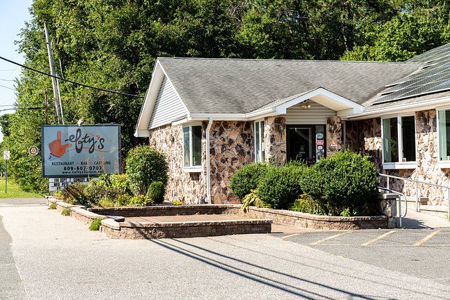 A small stone building with a sign that says ' lafayette 's ' on it