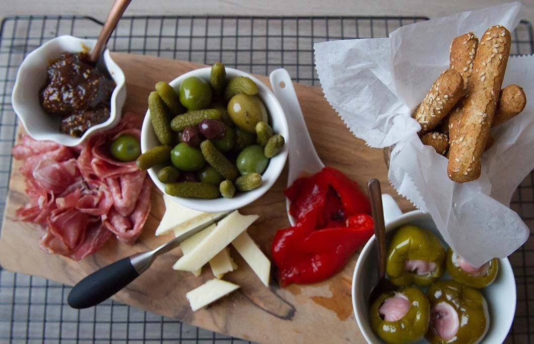 A wooden cutting board with a variety of food on it