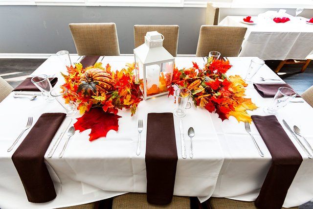 A table with a lantern and leaves on it