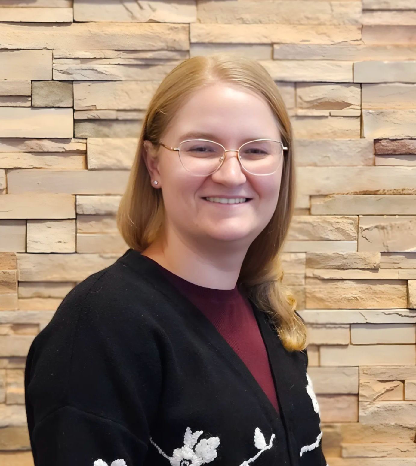 Madison smiling wearing a black sweater