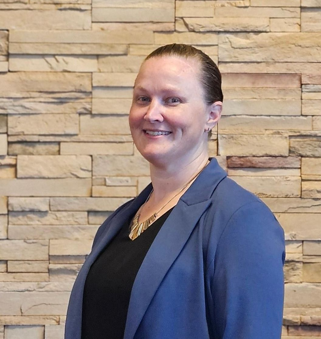 Sandie smiling in blue suit jacket