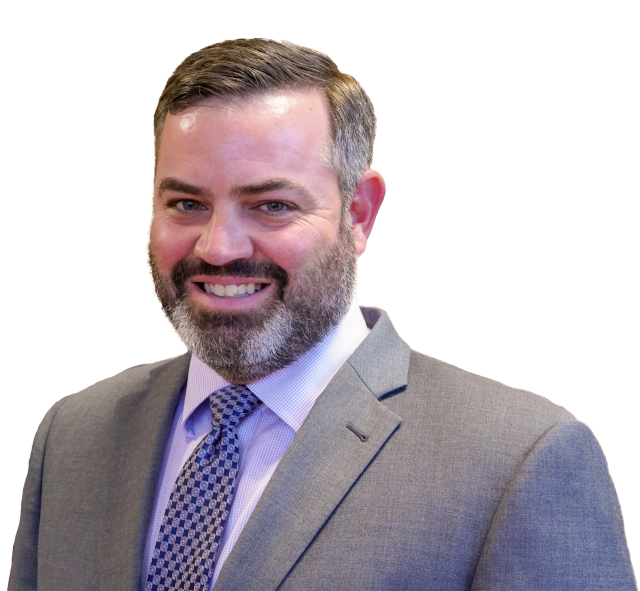 A man in a suit and tie smiles for the camera