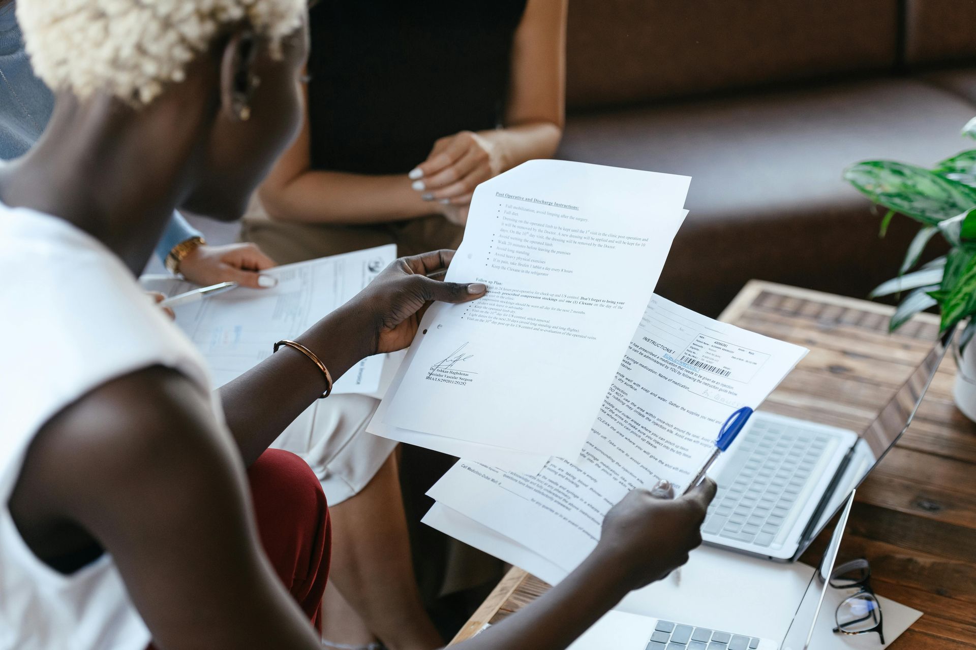 A picture of a woman holding various business documents 